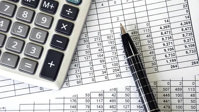 Calculator, pen and a printed accounts ledger